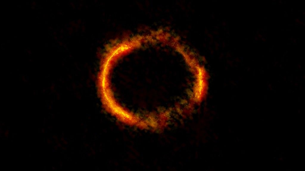 Soczewka grawitacyjna - obraz galaktyki SDP.81 uzyskany przez obserwatorium ALMA. Fot. ALMA (NRAO/ESO/NAOJ); B. Saxton NRAO/AUI/NSF
