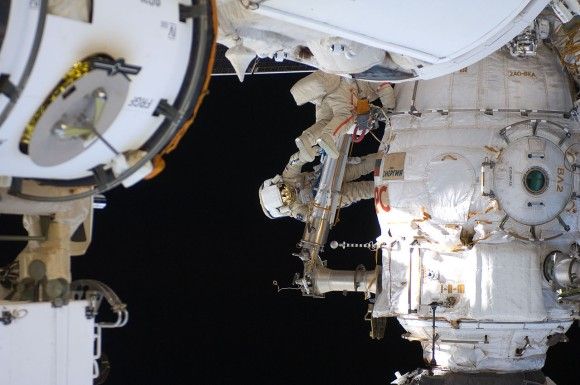 Fiodor Jurczichin (czerwone paski) i Oleg Skripoczka (niebieskie paski) podczas spaceru kosmicznego. Fot. NASA