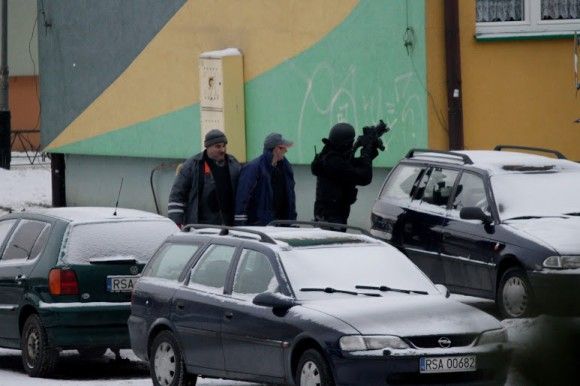 Policjanci osłaniają pracowników służb - fot. Artur Kucharski