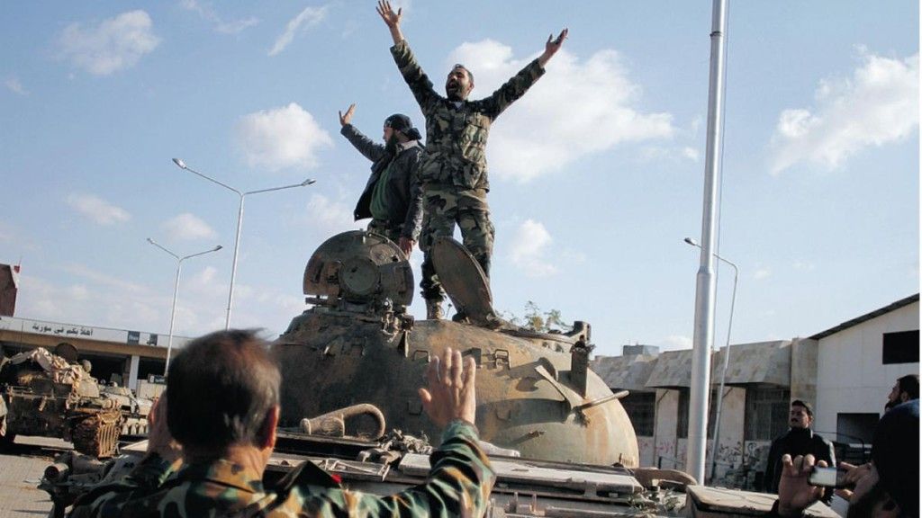 Jeden z rebeliantów cieszy się ze zdobycia czołgu sił reżymowych - fot. www.farah.net.au
