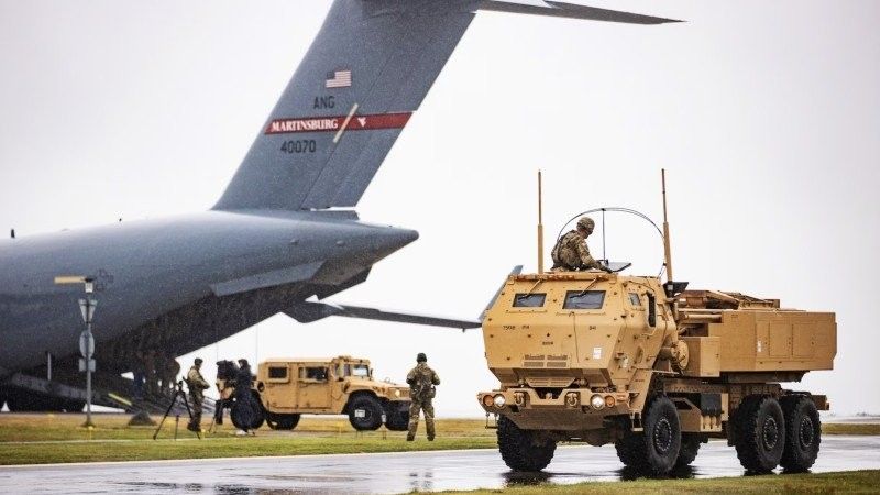 HIMARS and Humvee-based command vehicle, unloaded from US National Guard's C-17.
