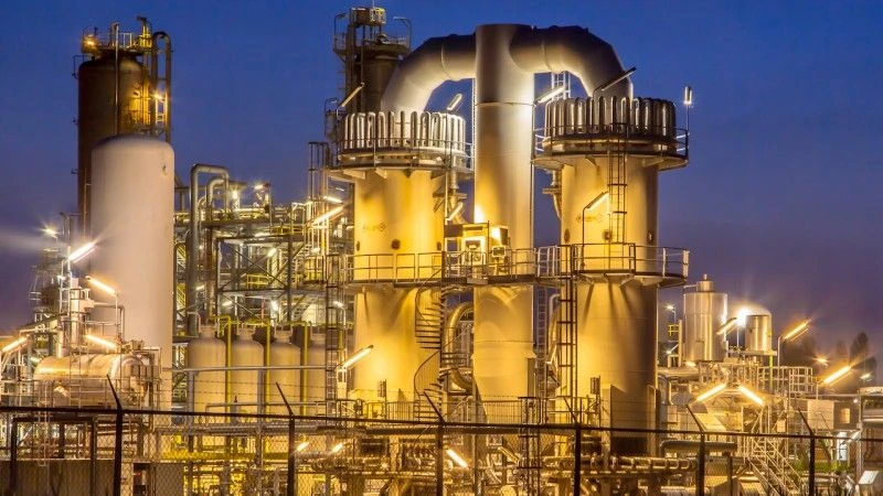 Duży, przemysłowy zakład chemiczny oświetlony w nocy