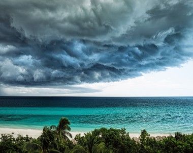 ciemne chmury zbierają się nad rajską plażą nad oceanem
