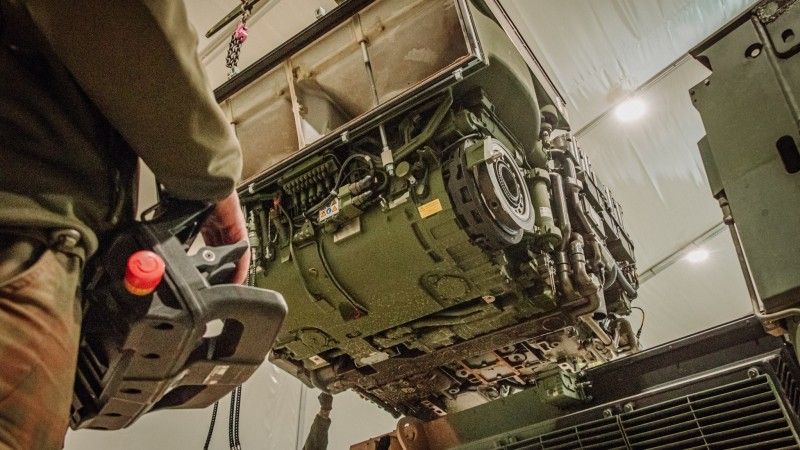 Wymiana zespołu napędowego w czołgu podstawowym K2 Black Panther. Kompletny powerpack z silnikiem wysokoprężnym HD Hyundai Infracore DV27K, przekładnią automatyczną RENK HSWL 295 TM i osprzętem waży ponad 5 ton.