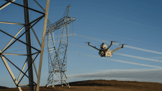 dron lecący przy liniach energetycznych
