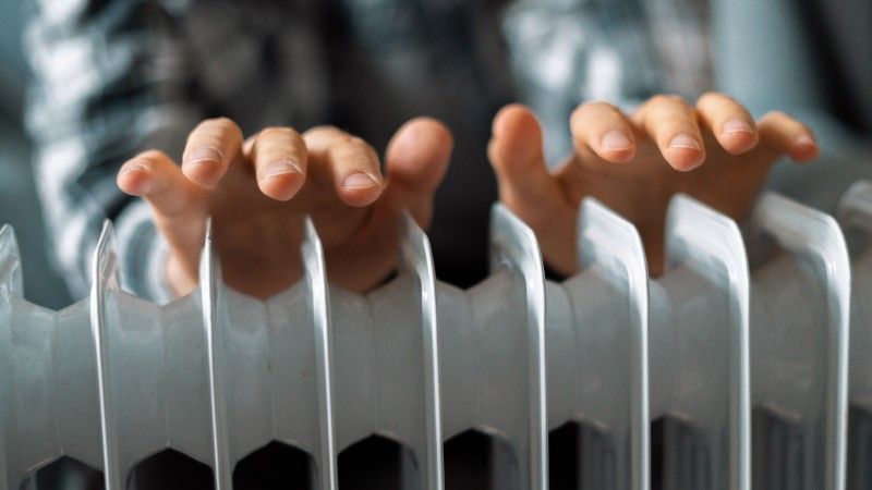 feeling-cold-getting-warm-hands-touching-heater-