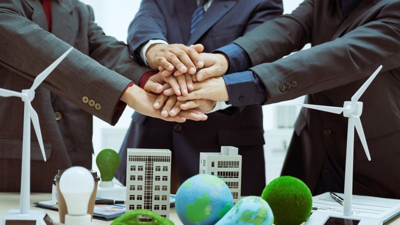 three-businessmen-meet-table-to-discuss-the-devel-2026-01-08-07-53-00-utc
