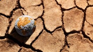 dry-earth-with-globe-symbolizing-climate-change-2026-03-25-09-20-46-utc