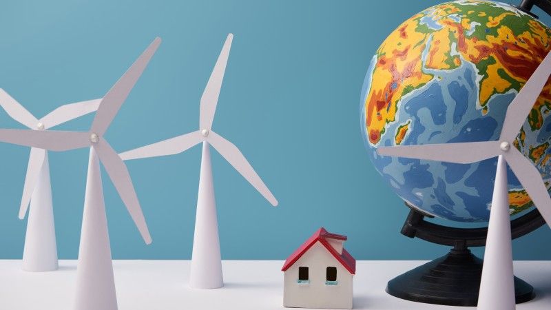 windmill-and-house-models-with-globe-on-white-tabl-2026-03-09-00-13-39-utc