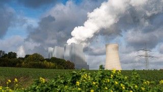 green-grassy-land-with-clouds-of-smoke-rising-from-2026-03-18-09-49-52-utc