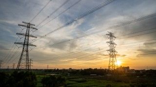 electricity-pylons-at-colorful-sunset-over-green-f-2026-03-24-03-46-07-utc