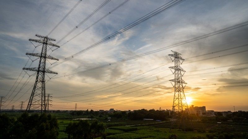 electricity-pylons-at-colorful-sunset-over-green-f-2026-03-24-03-46-07-utc