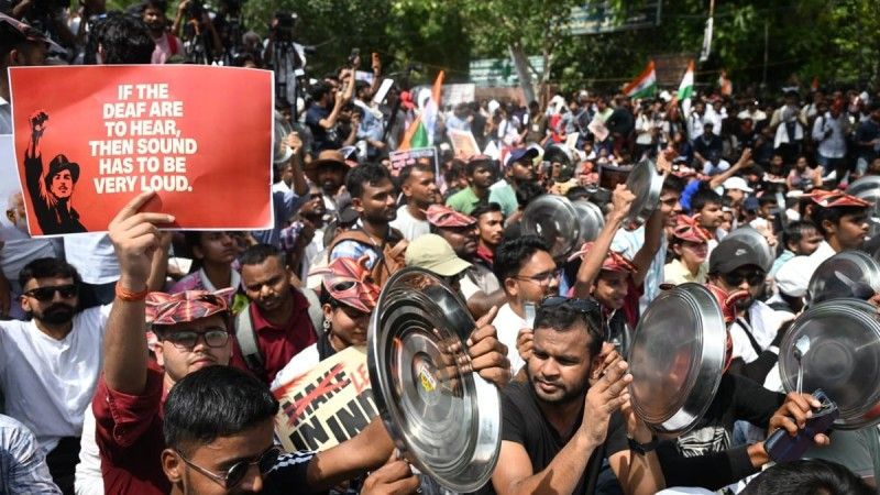 Cockroach janta party protestors holding posters of Bhagat Singh at Jantar Mantar with quote by Bhagat Singh: "If the deaf are to hear, the sound has to be very loud."