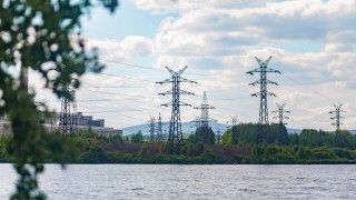 power-lines-over-water-near-industrial-building-2026-03-09-23-14-51-utc