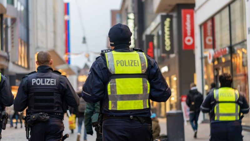 law-enforcement-officers-patrol-city-street-on-foo-2026-03-18-06-51-29-utc