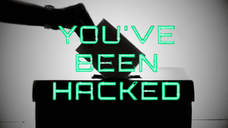 Urna do głosowania w wyborach z napisem "You've Been Hacked".