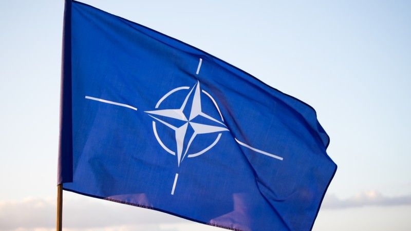 Flaga NATO na tle nieba - zdjęcie ilustracyjne