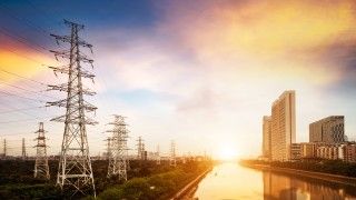 cityscape-at-sunset-with-towers-and-electrical-lin-2026-09-25-07-52-23-utc