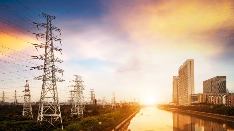 cityscape-at-sunset-with-towers-and-electrical-lin-2026-09-25-07-52-23-utc