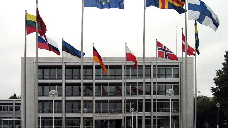 The Parliament of Åland with flags of the European Union, Åland, Finland, and other nearby countries.